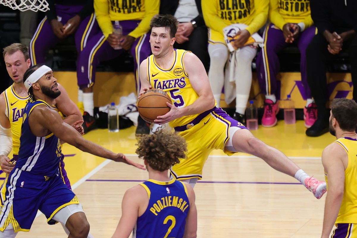 Los Angeles Lakers guard Austin Reaves (15) secures the loose rebound during an NBA game against the Golden State Warriors on February 7, 2025 in Los Angeles, CA.