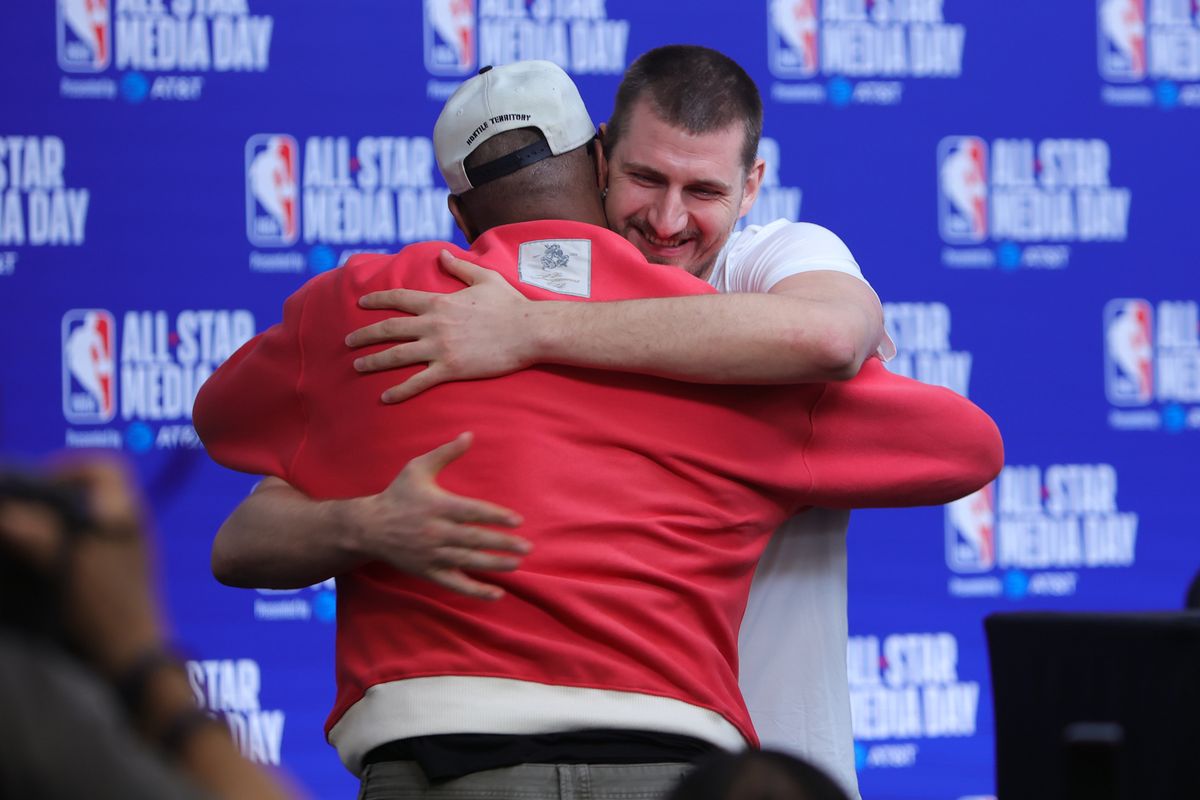 Denver Nuggets center Nikola Jokic (15) and former NBA player Demarcus Cousins embrace during media availability at NBA All Star Media Day on February 14, 2026 in Inglewood, CA.