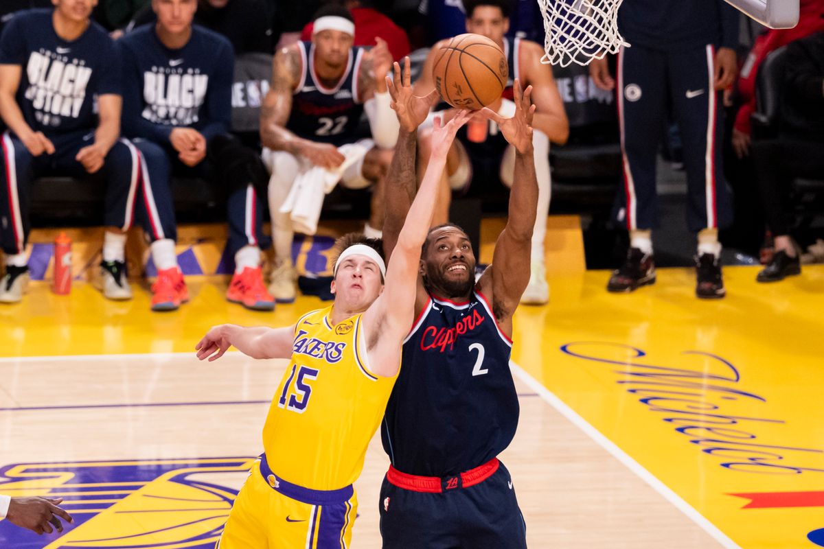 Austin Reaves #15 of the Los Angeles Lakers and Kawhi Leonard #2 of the LA Clippers reach for a rebound during an NBA basketball game, Friday February 20, 2026 in Los Angeles, Calif.