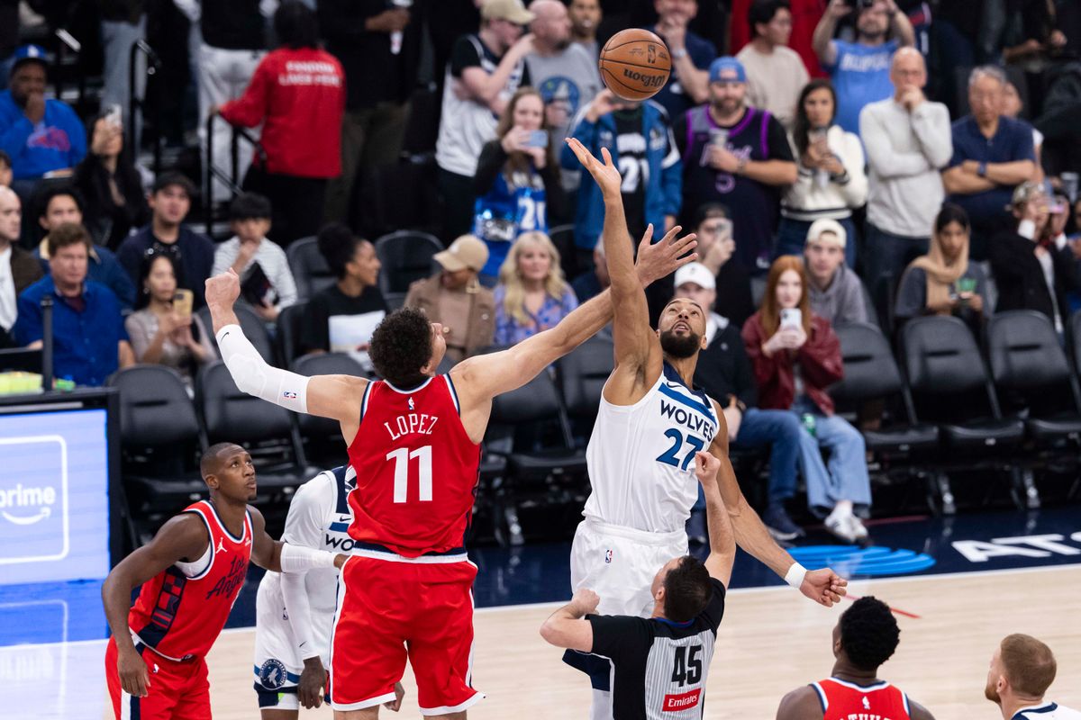 Brook Lopez #11 of the LA Clippers and Rudy Gobert #27 of the Minnesota Timberwolves reach for the opening tip-off during an NBA basketball game, Thursday February 26, 2026 in Inglewood, Calif.