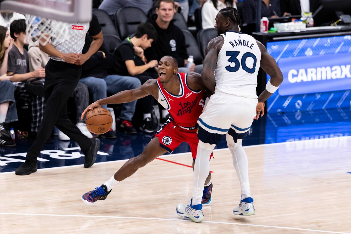 Kris Dunn #8 of the LA Clippers tries to get around Julius Randle #30 of the Minnesota Timberwolves during an NBA basketball game, Thursday February 26, 2026 in Inglewood, Calif.