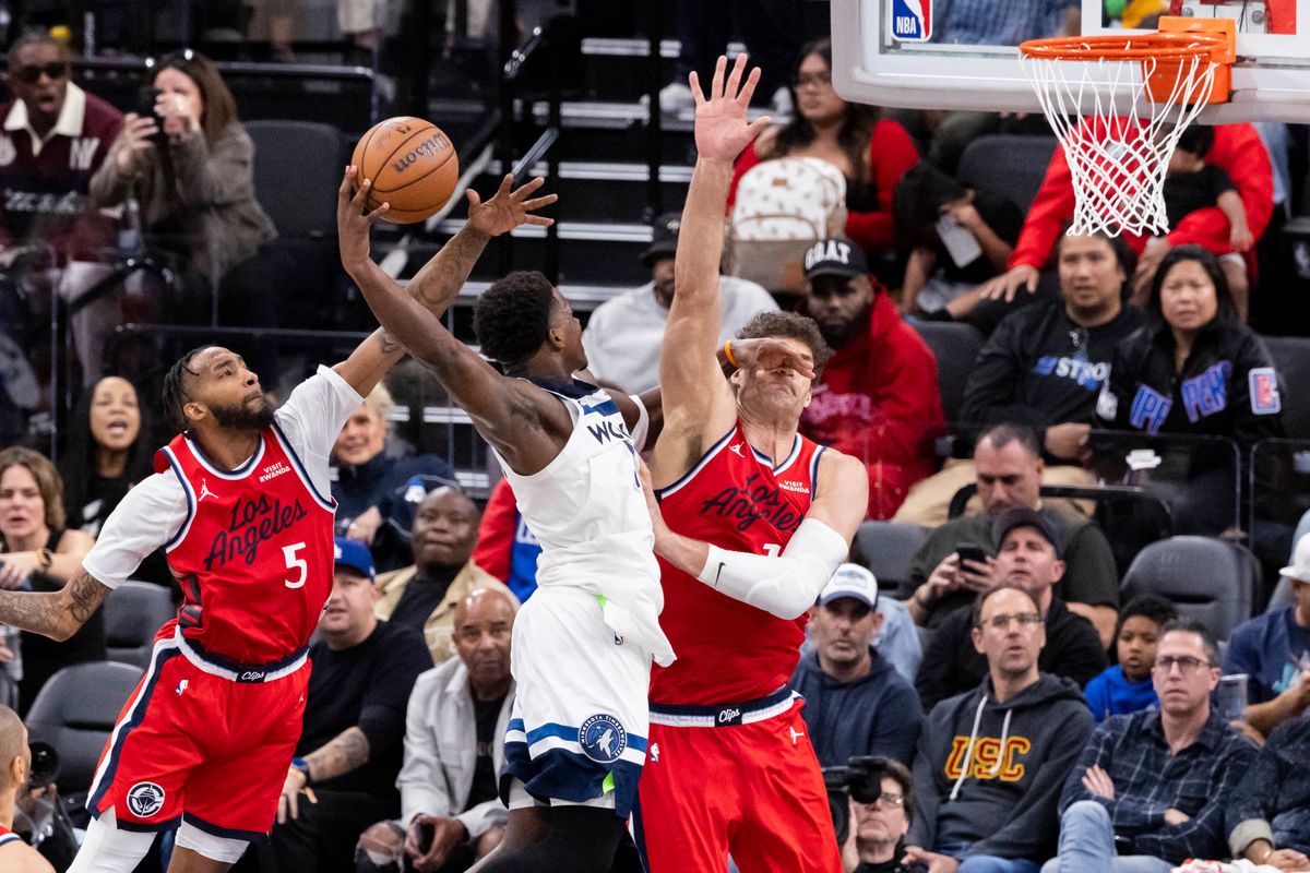 Anthony Edwards #5 of the Minnesota Timberwolves gets fouled by Derrick Jones Jr. #5 of the LA Clippers on a dunk attempt during an NBA basketball game, Thursday February 26, 2026 in Inglewood, Calif.