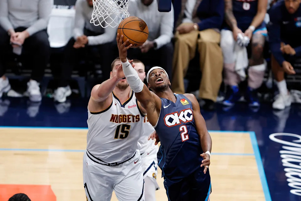 Feb 27, 2026; Oklahoma City, Oklahoma, USA; Oklahoma City Thunder guard Shai Gilgeous-Alexander (2) goes up for a basket in front of Denver Nuggets center Nikola Jokić (15) during the fourth quarter at Paycom Center. Mandatory Credit: Alonzo Adams-Imagn Images