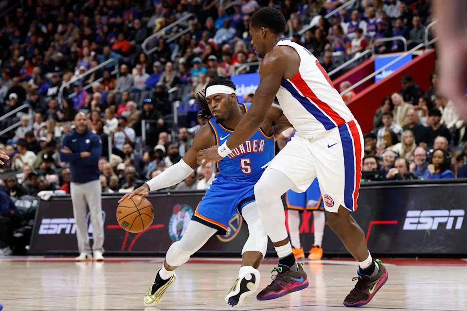 Feb 25, 2026; Detroit, Michigan, USA; Oklahoma City Thunder guard Luguentz Dort (5) dribbles defended by Detroit Pistons center Jalen Duren (0) in the second half at Little Caesars Arena. Mandatory Credit: Rick Osentoski-Imagn Images