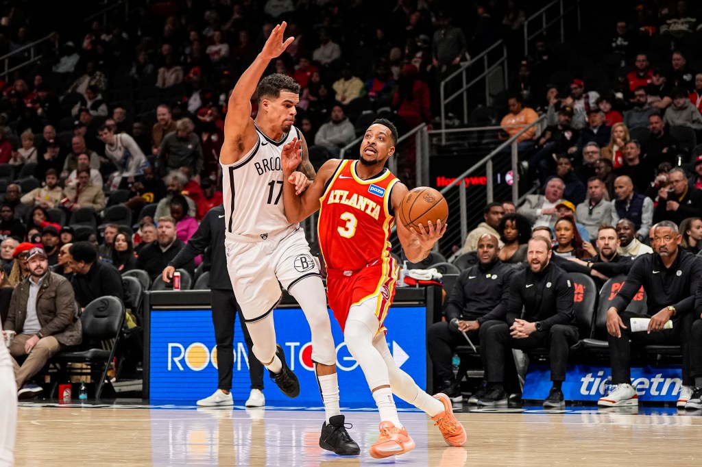 Atlanta Hawks guard C. J. McCollum (3) drives to the basket against Brooklyn Nets forward Michael Porter Jr. (17) during the second half at State Farm Arena.