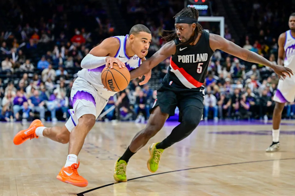 Oct 16, 2025; Salt Lake City, Utah, USA; Utah Jazz guard John Tonje (17) drives with the ball against Portland Trail Blazers guard Jrue Holiday (5) during the second half at Delta Center. Mandatory Credit: Peter Creveling-Imagn Images