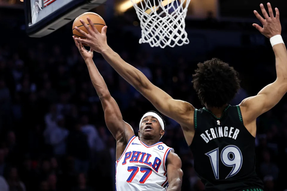 Feb 22, 2026; Minneapolis, Minnesota, USA; Philadelphia 76ers guard Vj Edgecombe (77) shoots as Minnesota Timberwolves forward Joan Beringer (19) defends during the first half at Target Center. Mandatory Credit: Matt Krohn-Imagn Images