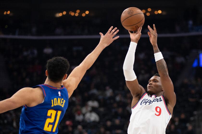 Los Angeles Clippers guard Bennedict Mathurin (9) shoots over Denver Nuggets forward Spencer Jones (21) during the first half of an NBA basketball game Thursday, Feb. 19, 2026, in Inglewood, Calif. (AP Photo/Kyusung Gong)