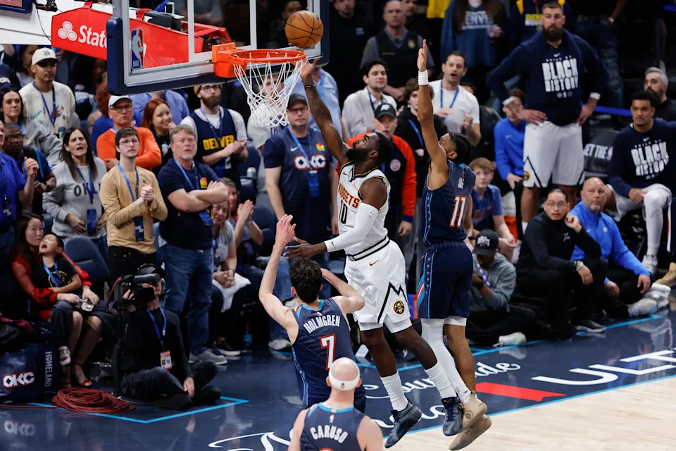 Feb 27, 2026; Oklahoma City, Oklahoma, USA; Denver Nuggets guard/forward Tim Hardaway Jr. (10) goes up for a basket between Oklahoma City Thunder guard Isaiah Joe (11) and center/forward Chet Holmgren (7) during overtime at Paycom Center. Mandatory Credit: Alonzo Adams-Imagn Images