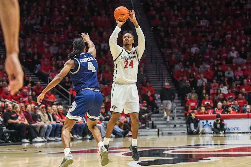 SDSU guard Taj DeGourville (24) shoots a 3PT jump shot1.42 during an NCAA Basketball game against Nevada Saturday February 14, 2026 in California.