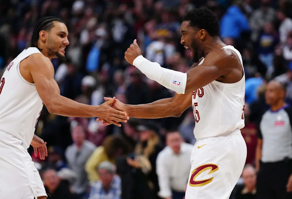 Cleveland Cavaliers guards Donovan Mitchell, right, and Jaylon Tyson celebrate after the Cavs defeated the Denver Nuggets on Feb. 9, 2026, in Denver, Colorado.