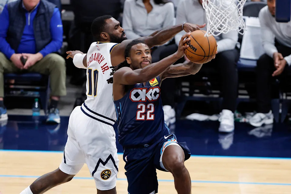 Feb 27, 2026; Oklahoma City, Oklahoma, USA; Oklahoma City Thunder guard Cason Wallace (22) goes up for a basket in front of Denver Nuggets guard/forward Tim Hardaway Jr. (10) during overtime at Paycom Center. Mandatory Credit: Alonzo Adams-Imagn Images