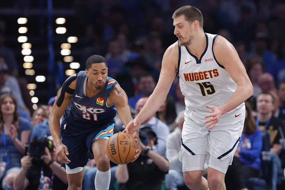 Feb 27, 2026; Oklahoma City, Oklahoma, USA; Oklahoma City Thunder guard Aaron Wiggins (21) steals the ball away from Denver Nuggets center Nikola Jokić (15) during the first quarter at Paycom Center. Mandatory Credit: Alonzo Adams-Imagn Images
