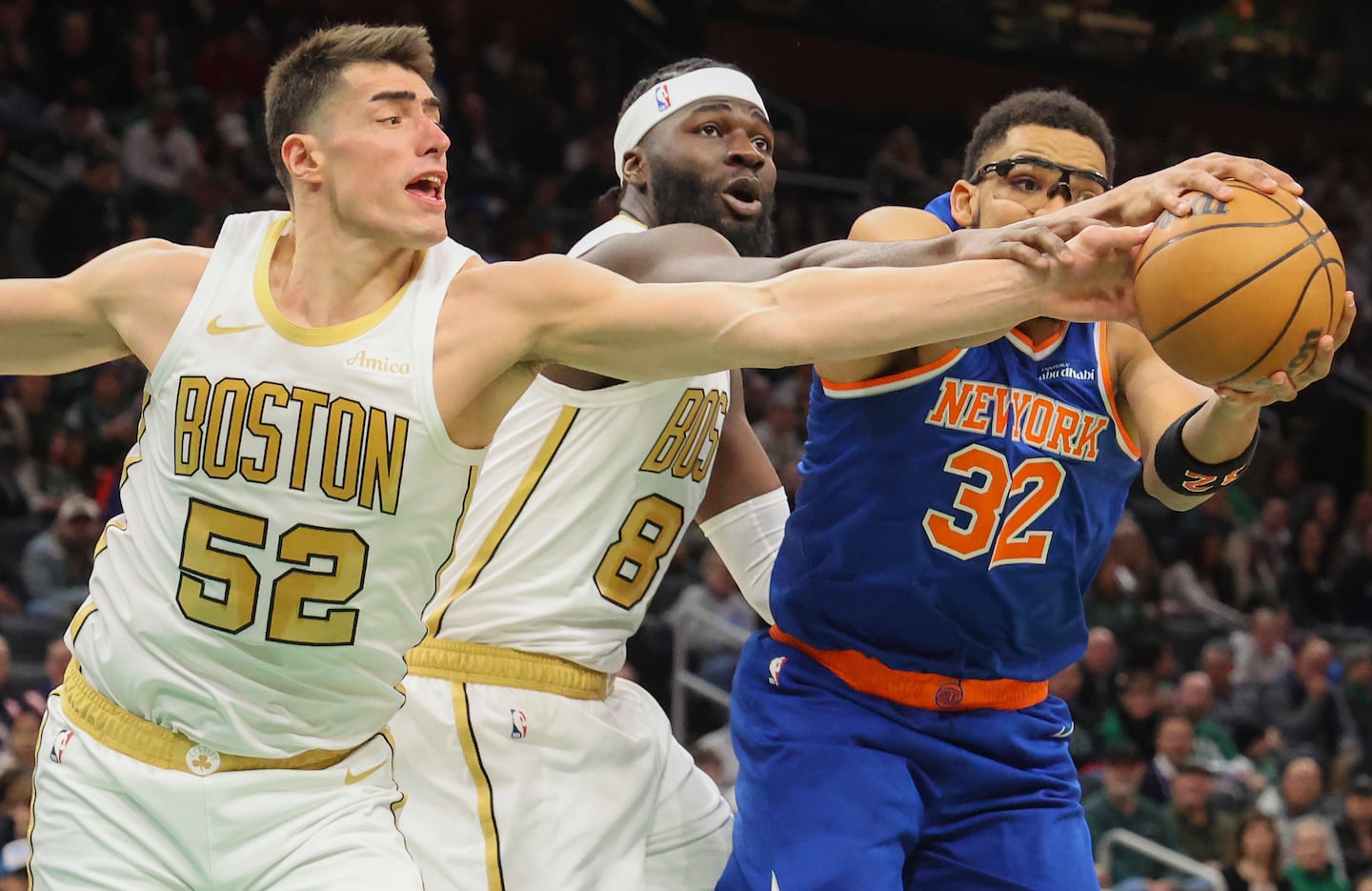 The Knicks' Karl-Anthony Towns outmuscled Celtics Luka Garza (left) and Neemias Queta for a rebound.