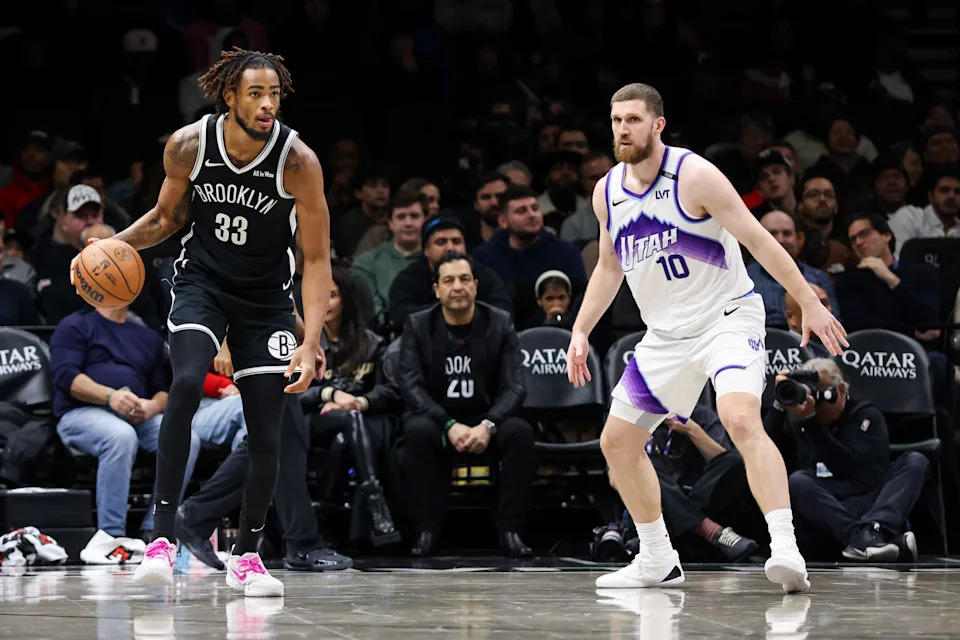 Dec 4, 2025; Brooklyn, New York, USA; Brooklyn Nets center Nic Claxton (33) dribbles the ball against Utah Jazz guard Svi Mykhailiuk (10) during the fourth quarter at Barclays Center. Mandatory Credit: Tom Horak-Imagn Images