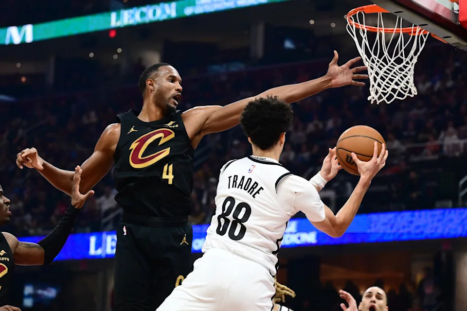 Cleveland Cavaliers forward Evan Mobley (4) tries to block the pass of Brooklyn Nets guard Nolan Traore (88) on Feb. 19, 2026, in Cleveland.