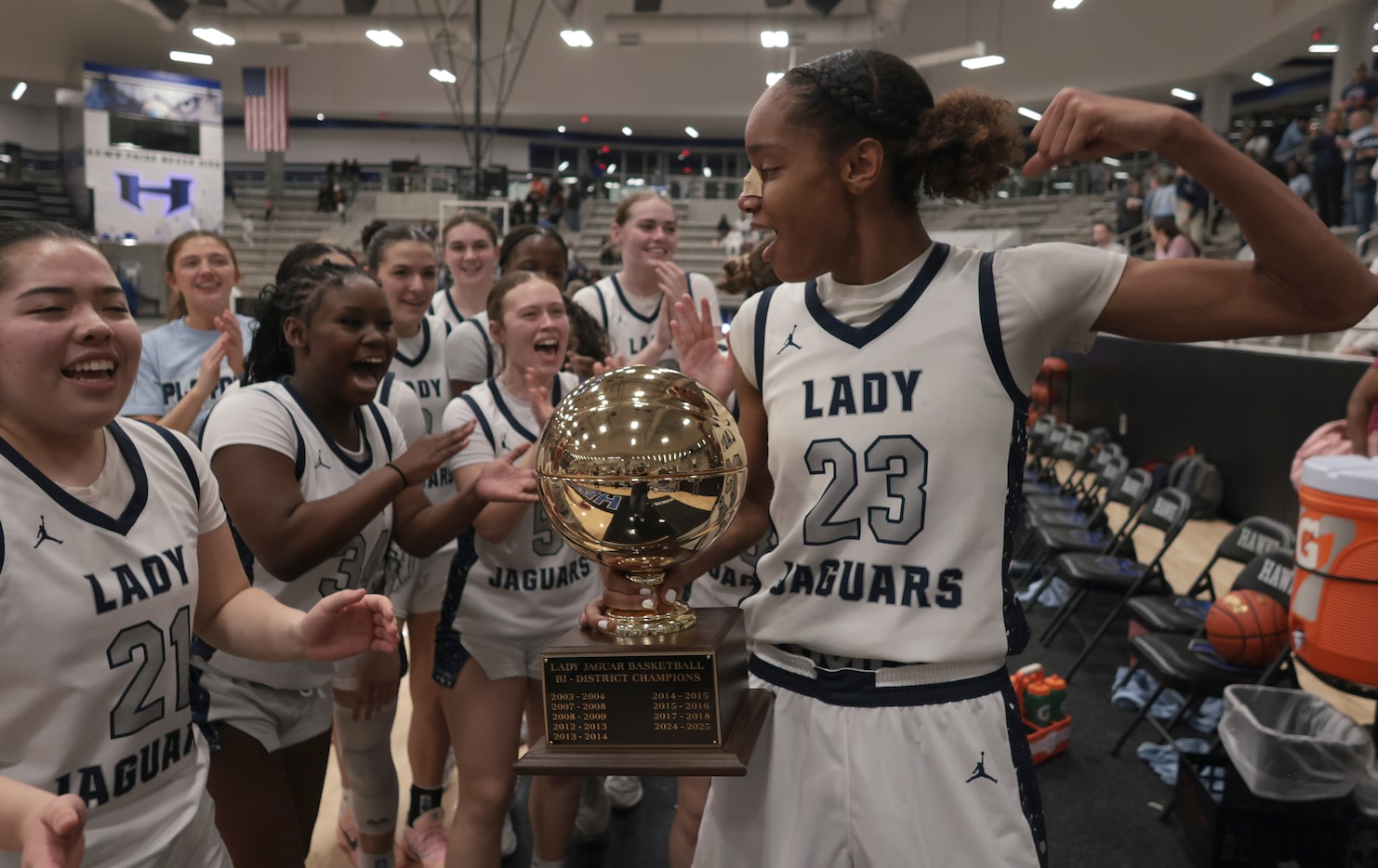 Flower Mound guard Maci Pringle (23) flexes as she celebrates with her teammates after they...
