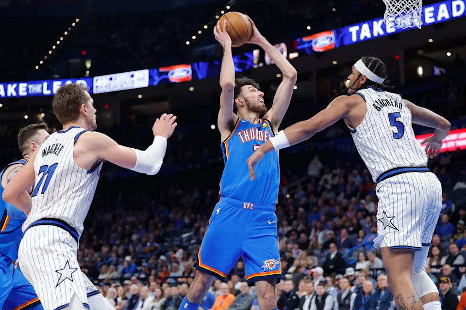 Feb 3, 2026; Oklahoma City, Oklahoma, USA; Oklahoma City Thunder center/forward Chet Holmgren (7) goes up for a basket between Orlando Magic center Orlando Robinson (7) and Oklahoma City Thunder guard Luguentz Dort (5) during the second half at Paycom Center. Mandatory Credit: Alonzo Adams-Imagn Images