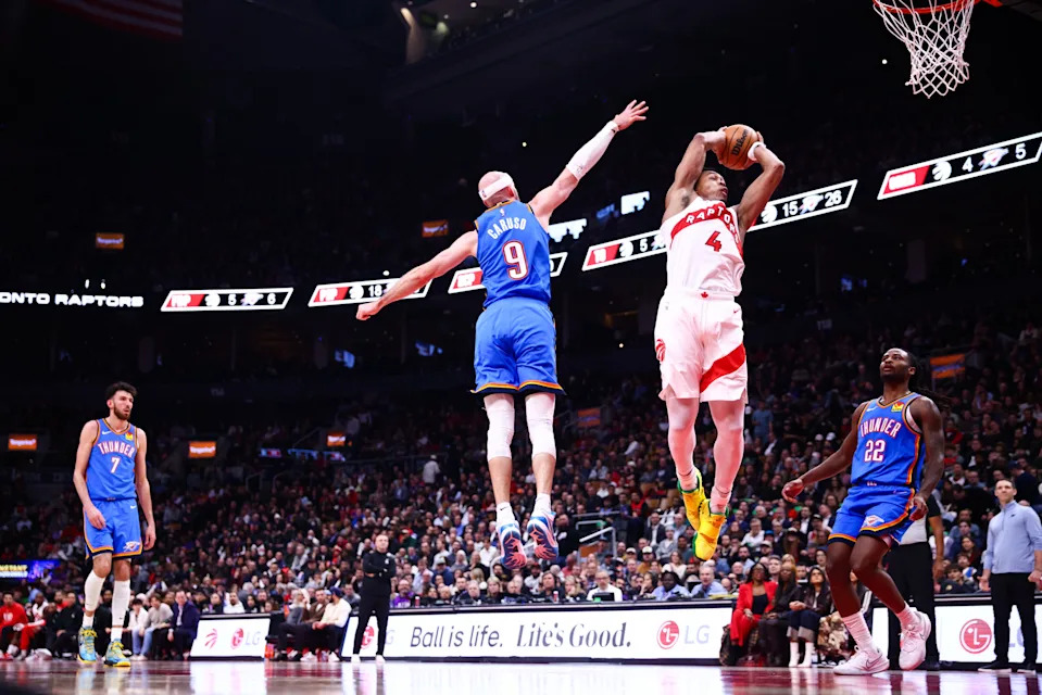 TORONTO, CANADA - FEBRUARY 24: Scottie Barnes #4 of the Toronto Raptors drives to the net against Alex Caruso #9 of the Oklahoma City Thunder during the first half of their NBA game at Scotiabank Arena on February 24, 2026 in Toronto, Ontario, Canada. NOTE TO USER: User expressly acknowledges and agrees that, by downloading and or using this photograph, User is consenting to the terms and conditions of the Getty Images License Agreement. (Photo by Cole Burston/Getty Images)