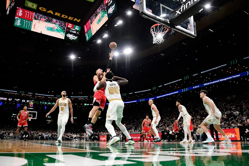 Jan 5, 2026; Boston, Massachusetts, USA; Chicago Bulls center Nikola Vucevic (9) shoots the ball over Boston Celtics center Neemias Queta (88) during the second half at TD Garden. Mandatory Credit: Bob DeChiara-Imagn Images