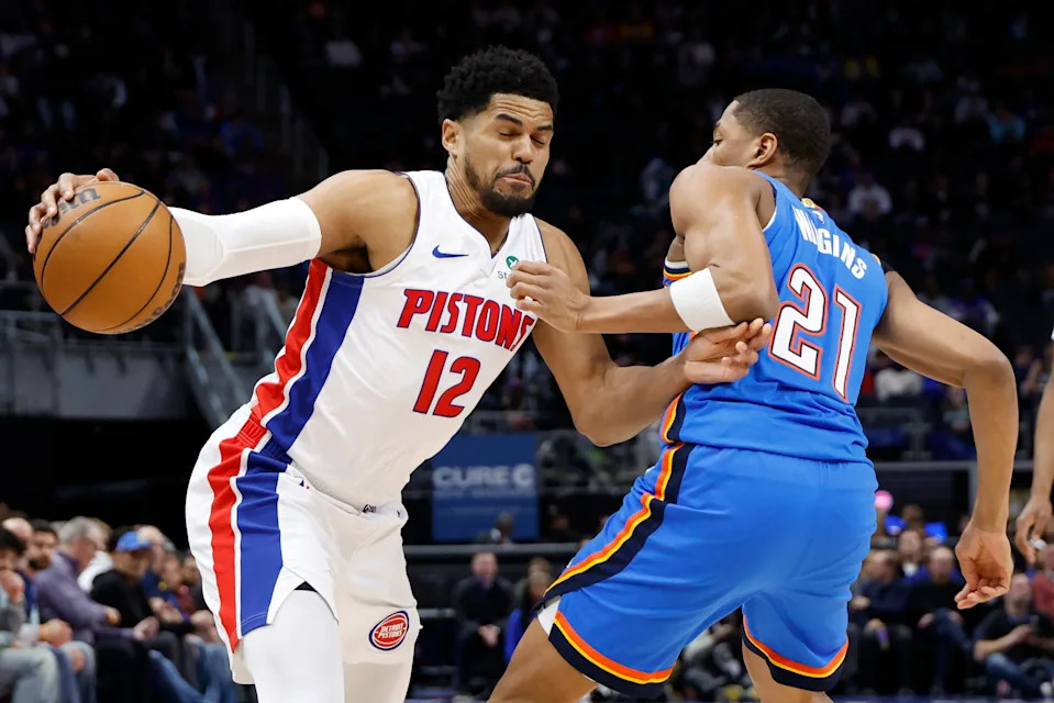 Feb 25, 2026; Detroit, Michigan, USA; Detroit Pistons forward Tobias Harris (12) dribbles defended by Oklahoma City Thunder guard Aaron Wiggins (21) in the first half at Little Caesars Arena. Mandatory Credit: Rick Osentoski-Imagn Images