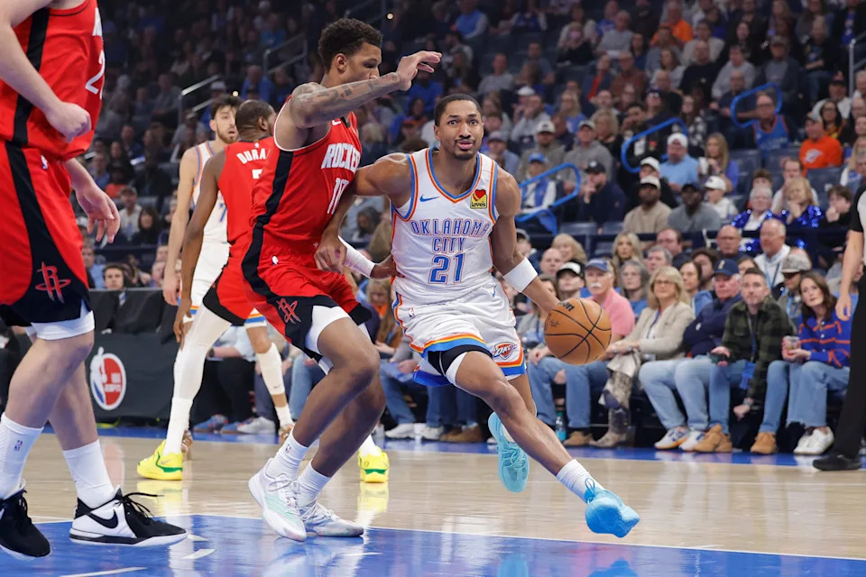 Feb 7, 2026; Oklahoma City, Oklahoma, USA; Oklahoma City Thunder guard Aaron Wiggins (21) drives past Houston Rockets forward Tari Eason (17) during the first half at Paycom Center. Mandatory Credit: Alonzo Adams-Imagn Images