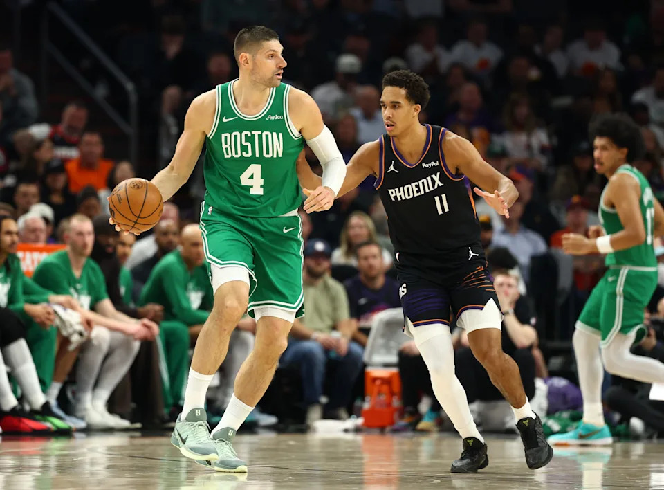 Feb 24, 2026; Phoenix, Arizona, USA; Boston Celtics center Nikola Vucevic (4) moves the ball against Phoenix Suns forward Oso Ighodaro (11) in the first half at Mortgage Matchup Center. Mandatory Credit: Mark J. Rebilas-Imagn Images