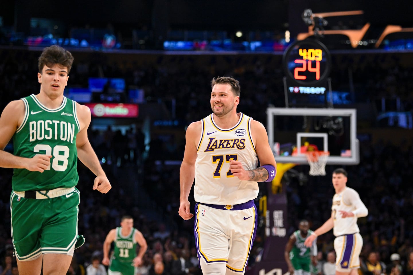 Lakers guard Luka Doncic smiled as he ran back downcourt after scoring on Celtics rookie Hugo Gonzalez on Sunday.