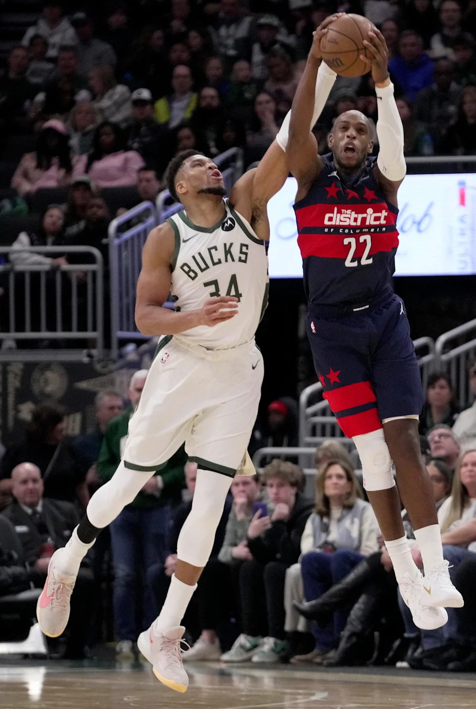 Milwaukee Bucks forward Giannis Antetokounmpo (34) guards Washington Wizards forward Khris Middleton (22) during the second half of their game Wednesday, December 31, 2025 at Fiserv Forum in Milwaukee, Wisconsin. The Washington Wizards beat the Milwaukee Bucks 114-113.