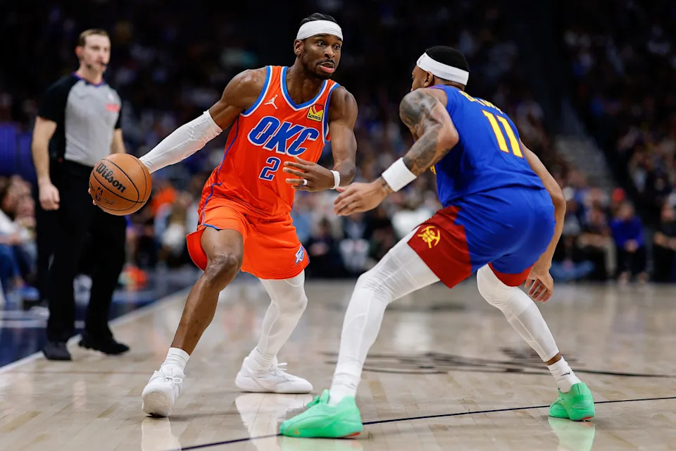 Feb 1, 2026; Denver, Colorado, USA; Oklahoma City Thunder guard Shai Gilgeous-Alexander (2) controls the ball as Denver Nuggets guard Bruce Brown (11) guards in the second quarter at Ball Arena. Mandatory Credit: Isaiah J. Downing-Imagn Images