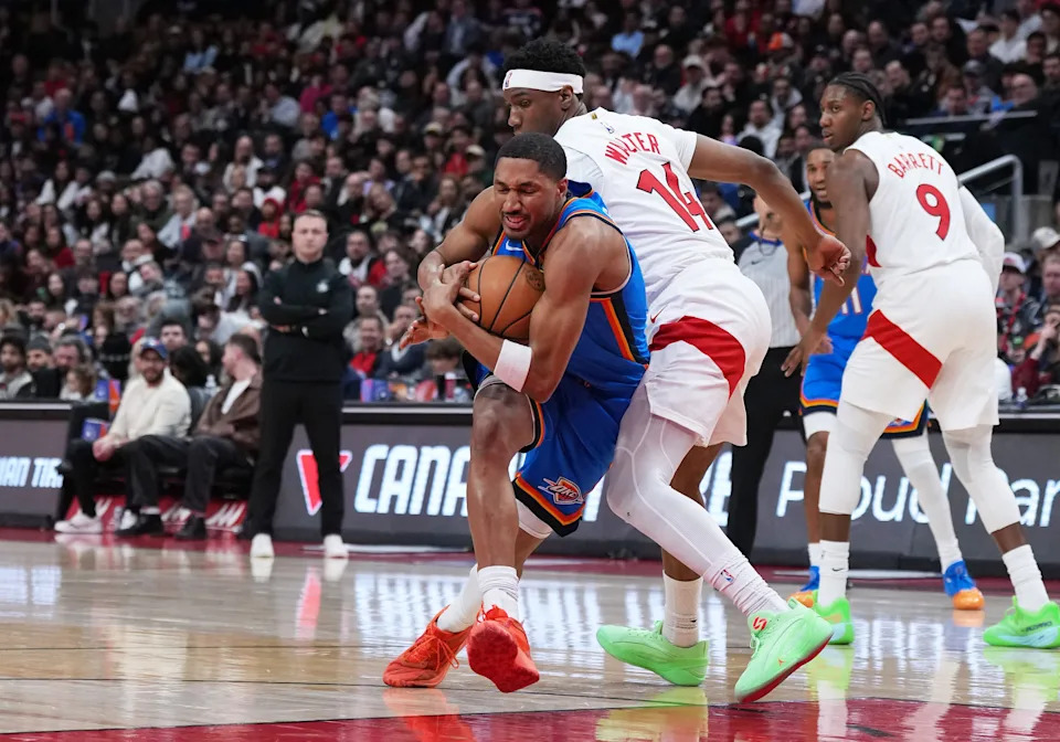 Feb 24, 2026; Toronto, Ontario, CAN; Oklahoma City Thunder guard Aaron Wiggins (21) battles for the ball with Toronto Raptors guard Ja kobe Walter (14) during the third quarter at Scotiabank Arena. Mandatory Credit: Nick Turchiaro-Imagn Images