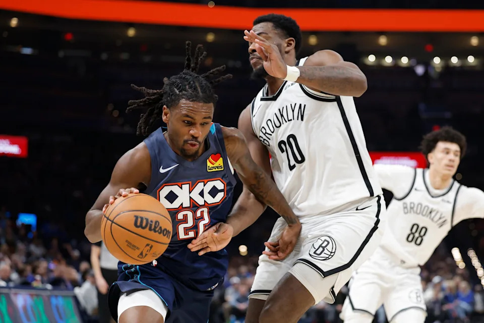 Feb 20, 2026; Oklahoma City, Oklahoma, USA; Oklahoma City Thunder guard Cason Wallace (22) drives past Brooklyn Nets center Day'ron Sharpe (20) during the second half at Paycom Center. Mandatory Credit: Alonzo Adams-Imagn Images