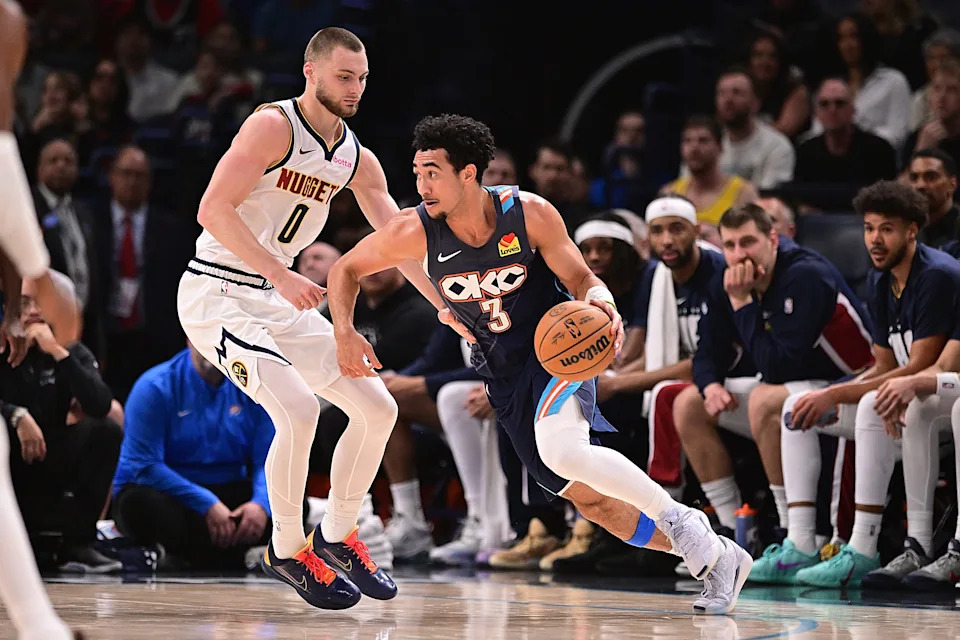 OKLAHOMA CITY, OKLAHOMA - FEBRUARY 27: Jared McCain #3 of the Oklahoma City Thunder hanldes the ball while being defended by Christian Braun #0 of the Denver Nuggets during the first half at Paycom Center on February 27, 2026 in Oklahoma City, Oklahoma. NOTE TO USER: User expressly acknowledges and agrees that, by downloading and or using this photograph, User is consenting to the terms and conditions of the Getty Images License Agreement. (Photo by Joshua Gateley/Getty Images)