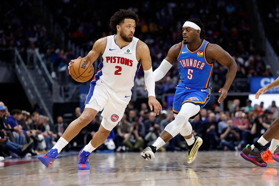 Feb 25, 2026; Detroit, Michigan, USA; Detroit Pistons guard Cade Cunningham (2) dribbles on Oklahoma City Thunder guard Luguentz Dort (5) in the first half at Little Caesars Arena. Mandatory Credit: Rick Osentoski-Imagn Images