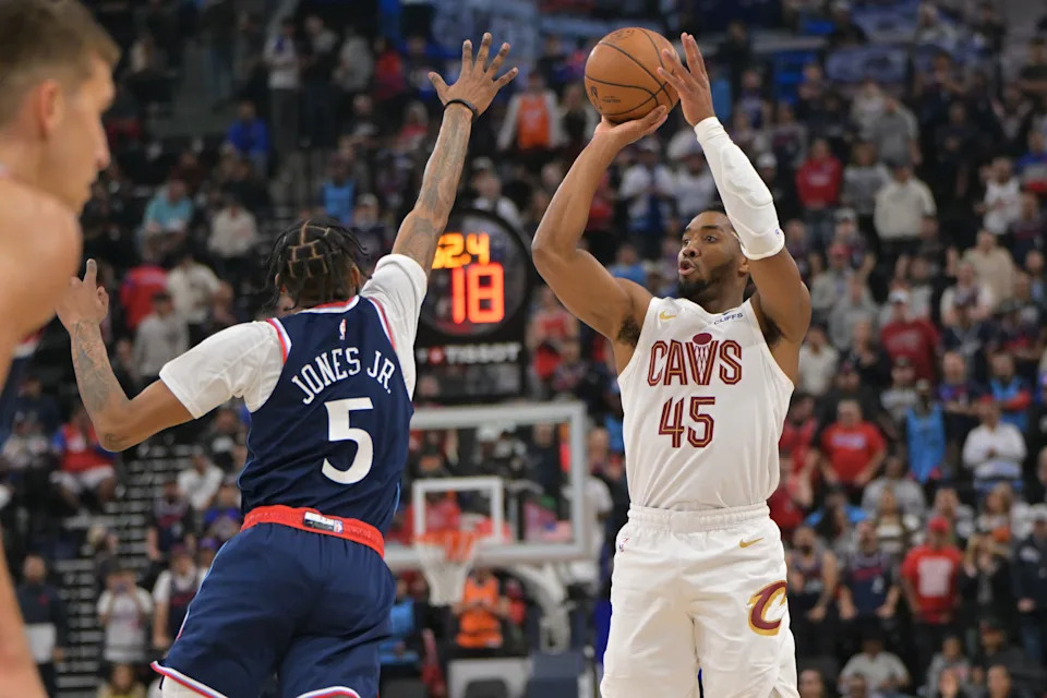Feb 4, 2026; Inglewood, California, USA; Los Angeles Clippers forward Derrick Jones Jr. (5) defends Cleveland Cavaliers guard Donovan Mitchell (45) as he shoots the ball in the first half at Intuit Dome. Mandatory Credit: Jayne Kamin-Oncea-Imagn Images