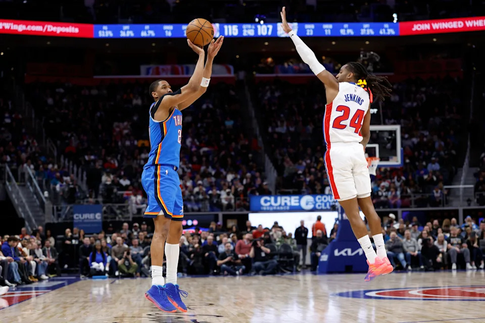 Feb 25, 2026; Detroit, Michigan, USA; Oklahoma City Thunder guard Aaron Wiggins (21) shoots on Detroit Pistons guard Daniss Jenkins (24) in the second half at Little Caesars Arena. Mandatory Credit: Rick Osentoski-Imagn Images