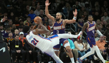 Philadelphia 76ers center Joel Embiid (21) is fouled by Phoenix Suns...