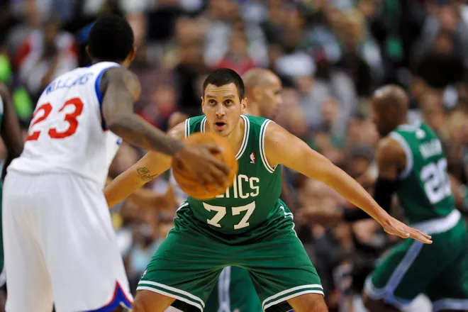 Mar 11, 2011; Philadelphia, PA, USA; Boston Celtics forward Sasha Pavlovic (77) defends the dribble of Philadelphia 76ers guard Louis Williams (23) during the fourth quarter at the Wells Fargo Center. The 76ers defeated the Celtics 89-86. Mandatory Credit: Howard Smith-USA TODAY Sports