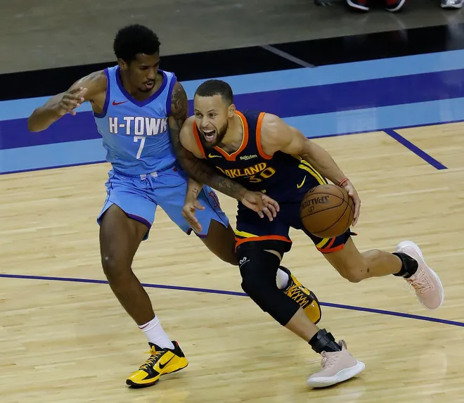 May 1, 2021; Houston, Texas, USA; Golden State Warriors guard Stephen Curry (30) drives against Houston Rockets guard Armoni Brooks (7) during the second quarter at Toyota Center. Mandatory Credit: Bob Levey /POOL PHOTOS-USA TODAY Sports