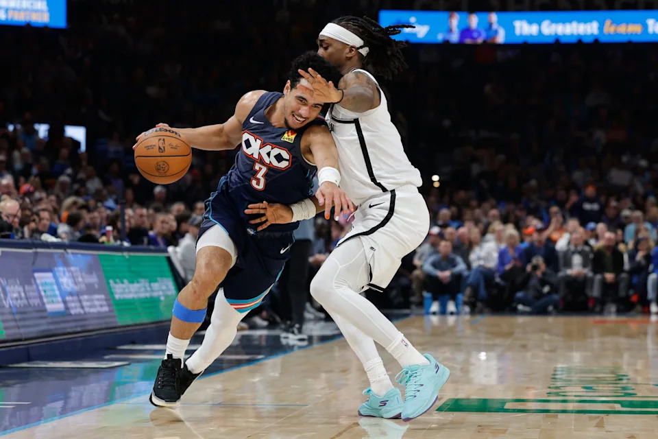 Feb 20, 2026; Oklahoma City, Oklahoma, USA; Oklahoma City Thunder guard Jared McCain (3) drives past Brooklyn Nets guard/forward Terance Mann (14) during the second half at Paycom Center. Mandatory Credit: Alonzo Adams-Imagn Images