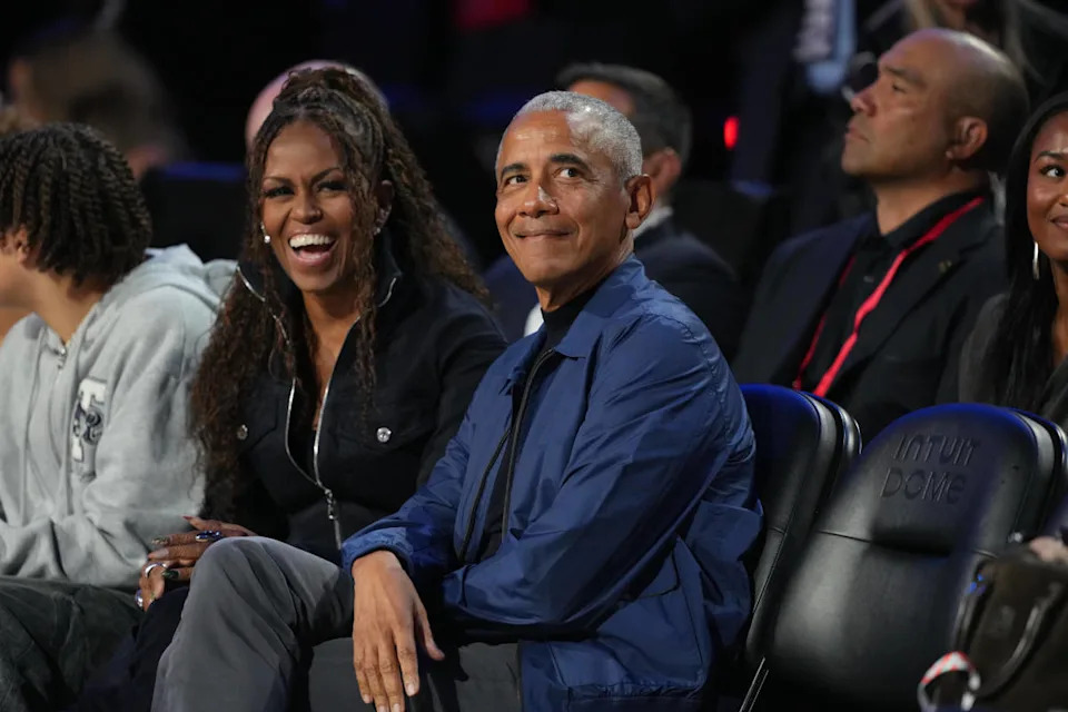 Former first lady Michelle Obama and former President Barack Obama look on before the start of the 75th NBA All Star Game at Intuit Dome.Kirby Lee-Imagn Images