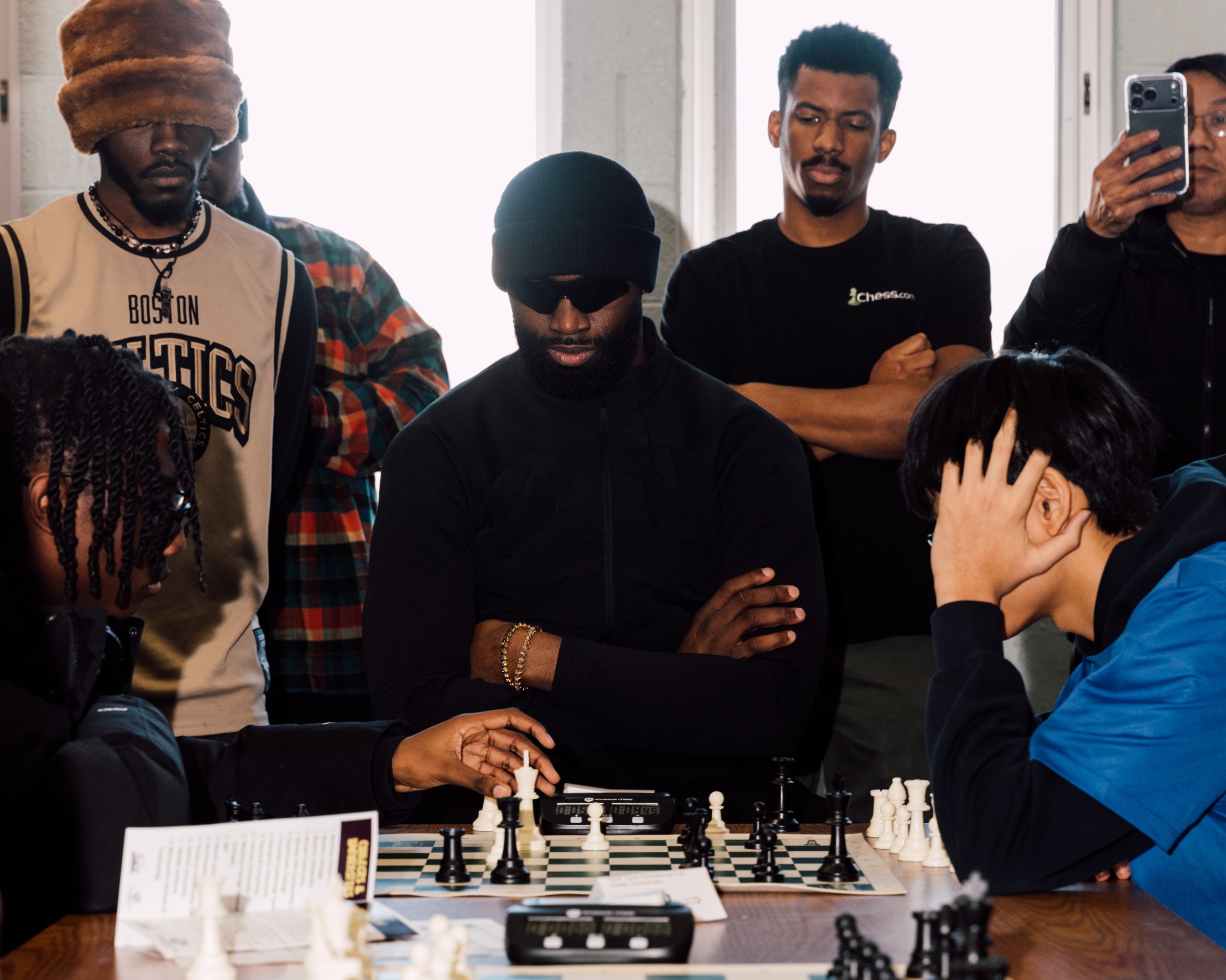 Jaylen Brown watched kids play chess at the Roxbury Boys and Girls Club, as part of an event held by the Future Masters Chess Academy.