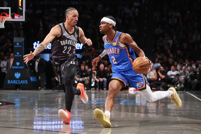 Feb 26, 2025; Brooklyn, New York, USA; Oklahoma City Thunder guard Shai Gilgeous-Alexander (2) looks to drive past Brooklyn Nets forward Jalen Wilson (22) in the first quarter at Barclays Center. Mandatory Credit: Wendell Cruz-Imagn Images