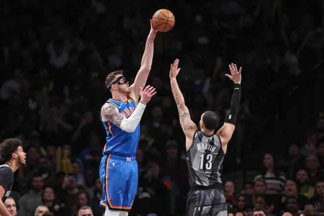 Feb 26, 2025; Brooklyn, New York, USA; Oklahoma City Thunder center Isaiah Hartenstein (55) shoots over Brooklyn Nets guard Tyrese Martin (13) in the third quarter at Barclays Center. Mandatory Credit: Wendell Cruz-Imagn Images