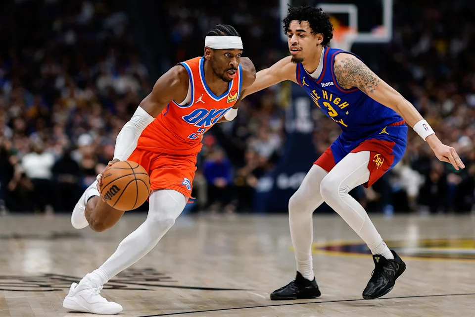 Feb 1, 2026; Denver, Colorado, USA; Oklahoma City Thunder guard Shai Gilgeous-Alexander (2) controls the ball as Denver Nuggets guard Julian Strawther (3) guards in the first quarter at Ball Arena. Mandatory Credit: Isaiah J. Downing-Imagn Images