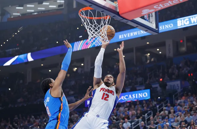 Apr 2, 2025; Oklahoma City, Oklahoma, USA; Detroit Pistons forward Tobias Harris (12) shoots as Oklahoma City Thunder forward Jalen Williams (8) defends during the first quarter at Paycom Center. Mandatory Credit: Alonzo Adams-Imagn Images