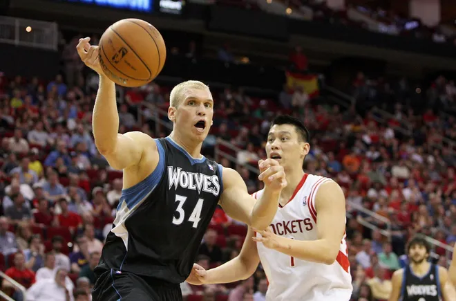 Mar 15, 2013; Houston, TX, USA; Minnesota Timberwolves center Greg Stiemsma (34) and Houston Rockets point guard Jeremy Lin (7) attempt to get control of the ball during the second quarter at Toyota Center. Mandatory Credit: Troy Taormina-USA TODAY Sports