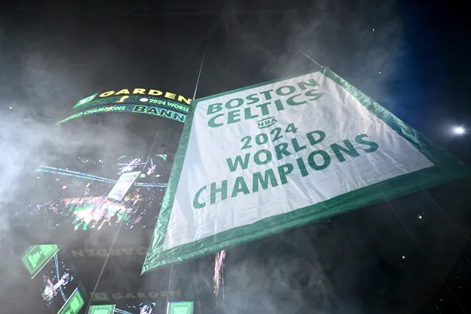BOSTON, MASSACHUSETTS - OCTOBER 22: The Boston Celtics 2024 Championship banner is raised before the game against the New York Knicks at TD Garden on October 22, 2024 in Boston, Massachusetts. (Photo by Brian Fluharty/Getty Images)