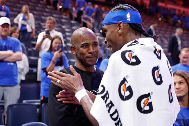 May 22, 2025; Oklahoma City, Oklahoma, USA; Oklahoma City Thunder guard Shai Gilgeous-Alexander (2) talks to Chris Paul after defeating the Minnesota Timberwolves during game two of the western conference finals for the 2025 NBA Playoffs at Paycom Center. Mandatory Credit: Alonzo Adams-Imagn Images