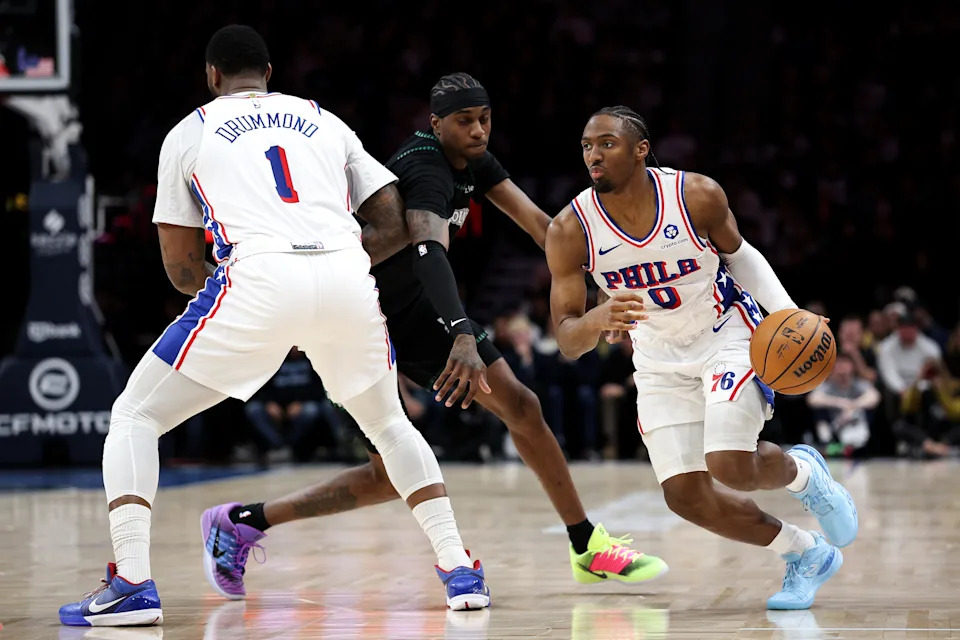 Feb 22, 2026; Minneapolis, Minnesota, USA; Philadelphia 76ers guard Tyrese Maxey (0) works around Minnesota Timberwolves forward Jaden McDaniels (3) during the first half at Target Center. Mandatory Credit: Matt Krohn-Imagn Images | Matt Krohn-Imagn Images